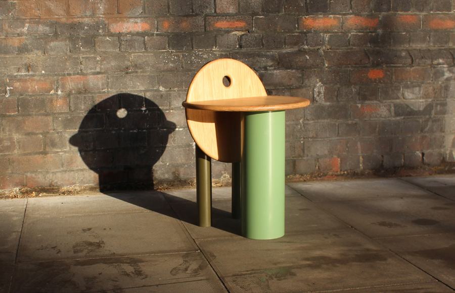 Workshop Stool casting its shadow on a brick wall