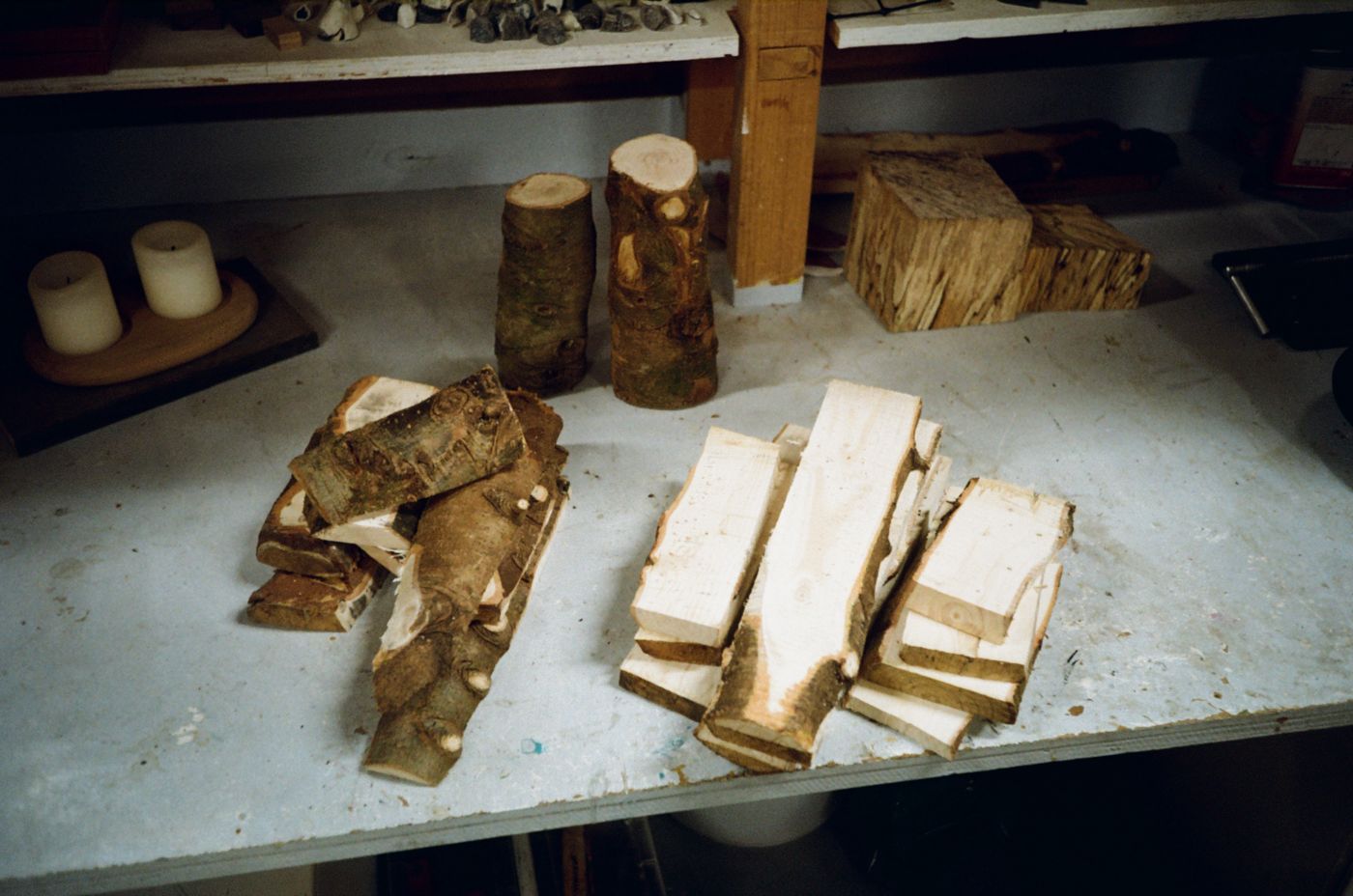 Christmas tree trunk sections and planks laid out on a workbench
