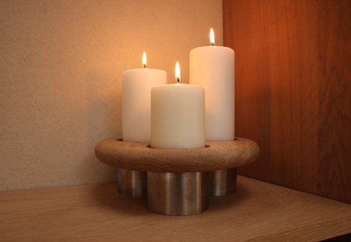 Triple holder lit in a warm corner