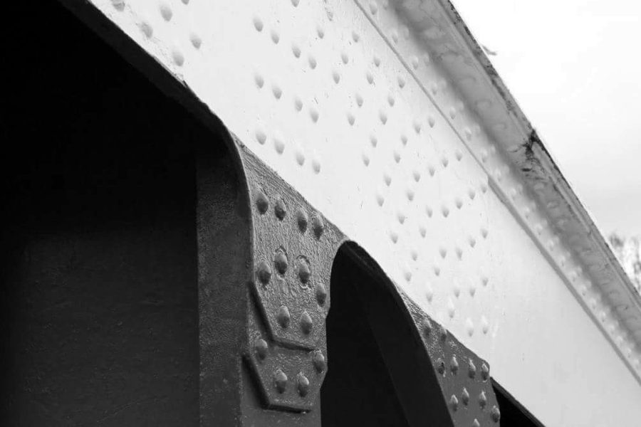 Riveted red girder meeting the white upper beam of the Tyne Swing Bridge